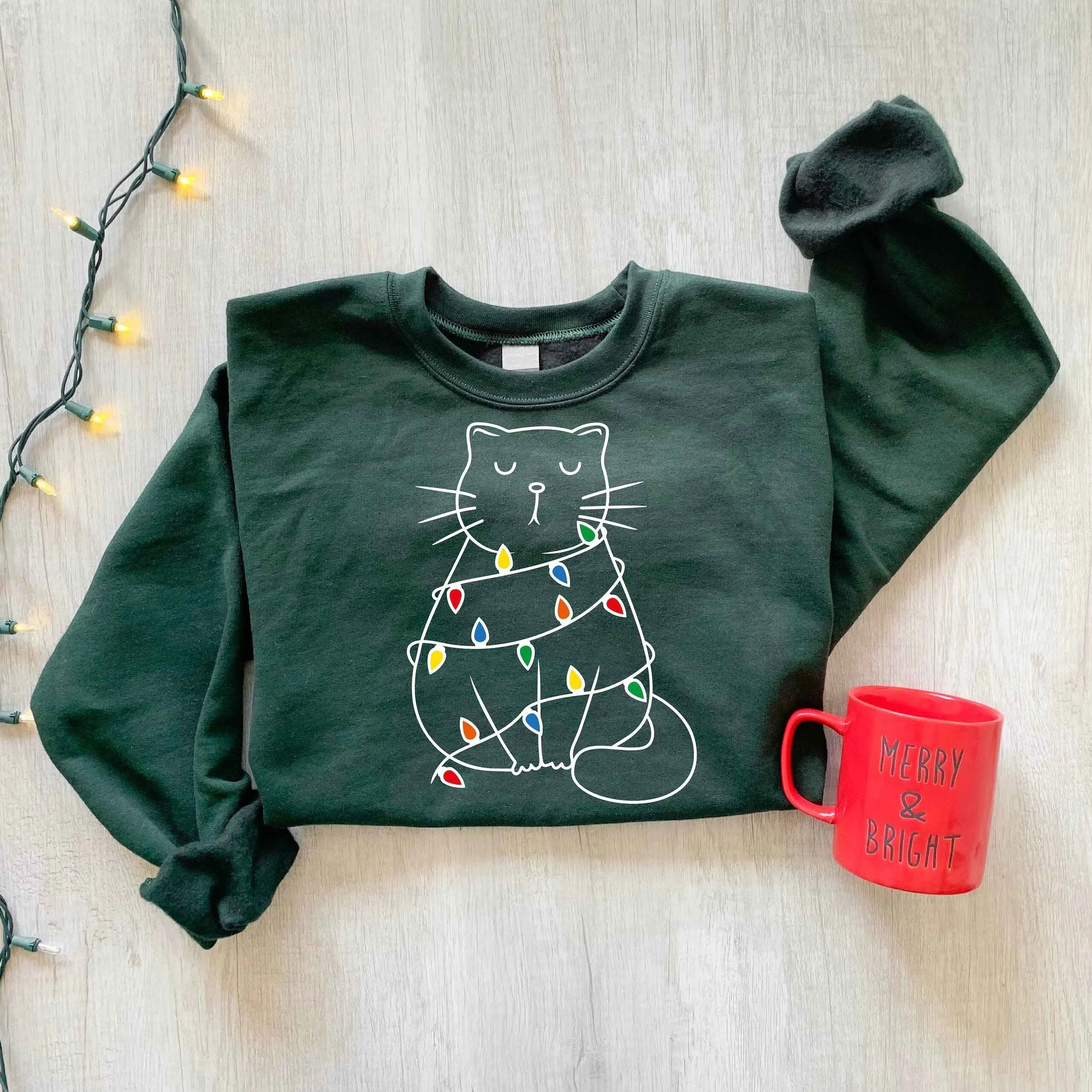 Cozy Cat Wrapped in Christmas Lights Sweatshirt – Pastel Pink Holiday Edition