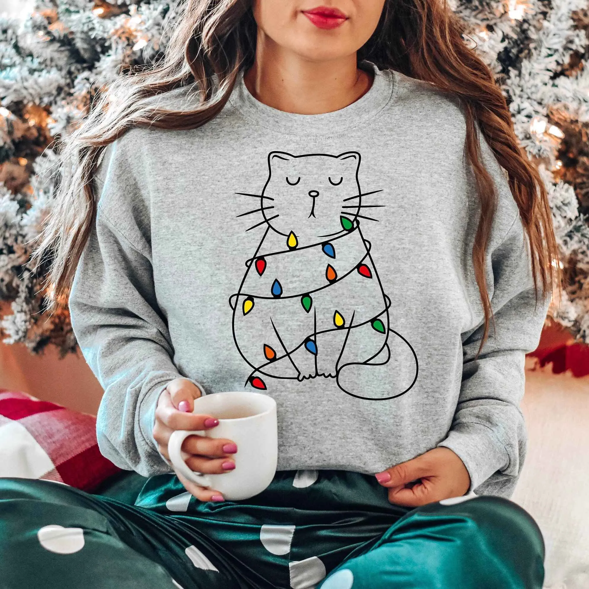 Cozy Cat Wrapped in Christmas Lights Sweatshirt – Pastel Pink Holiday Edition